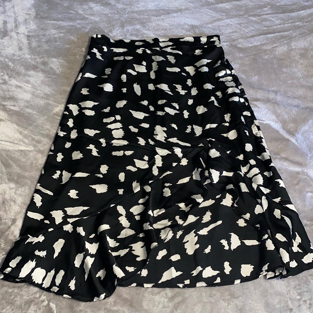 Black Medium Length Skirt with an off white/ beige patterns